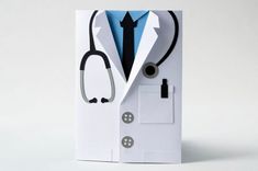 a white card with a stethoscope on it and a blue shirt underneath