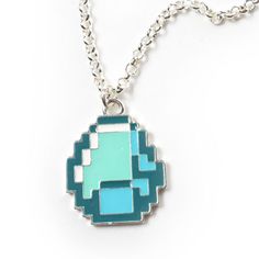 a blue and green necklace on a silver chain with an 8 - bit pacman charm