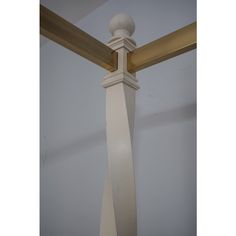 a close up of a pole with a white ball on it's end and wood posts