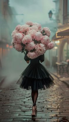 a woman is walking down the street with a bouquet of flowers on her head in front of her