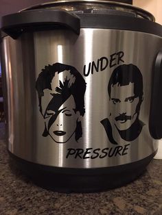 a stainless steel crock pot with the words under pressure on it and two men's faces