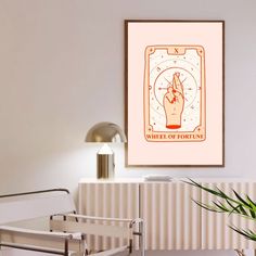 a poster hanging on the wall above a bed in a room with a chair and lamp