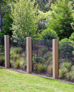 the fence is made out of wood and wire, along with some plants growing on it