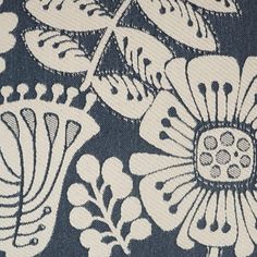 a blue and white floral print fabric with black accents on the bottom half of it