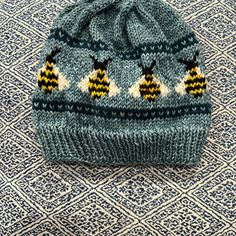 a knitted hat sitting on top of a rug