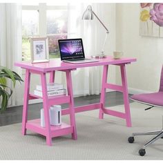 a pink desk with a laptop on it