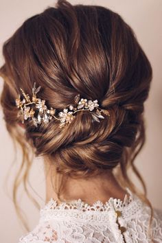 a woman wearing a hair comb with flowers in it