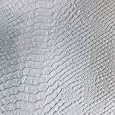 an up close view of the texture of white leather with wavy lines and ridges on it