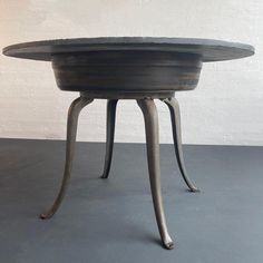 a round table sitting on top of a gray floor