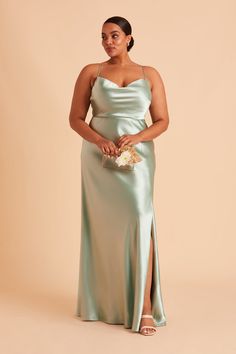 Featuring a 90's cowl neck, this floor-length shiny satin bridesmaid dress is a head-turning statuesque beauty. Available in Sage. Our satin midi got a glow-up! | Sage Bridesmaid Dress Shiny Satin Size 2X | Birdy Grey Lisa Long Curvy Bridesmaid Dresses, Light Green Bridesmaid Dresses, Green Satin Bridesmaid Dresses, Sage Bridesmaid Dresses, Green Satin Dress, Bridesmaid Dresses Under 100, Satin Gowns, Satin Bridesmaid Dress, Sage Green Bridesmaid Dress