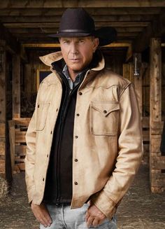 a man wearing a cowboy hat and leather jacket