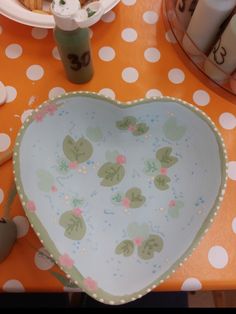 a heart shaped dish sitting on top of a table