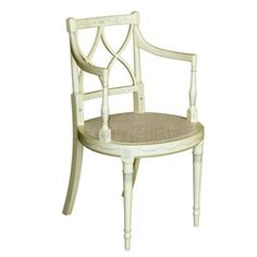 a white wooden chair with wicker seat