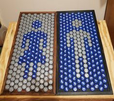 two beer cans sitting on top of a wooden table covered in blue and silver circles