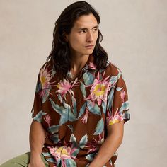 This shirt is a part of a special collaboration between Polo Ralph Lauren and Hoffman Fabrics. The original pattern was sourced from the personal archive of Mr. Walter Hoffman whose iconic tropical-print textiles have been a staple of modern surfwear since the 1950s. It was then updated specifically for us to make it distinctly Polo. Relaxed Fit Shirt With Hibiscus Print And Camp Collar, Tropical Tops With Camp Collar And All Over Print, Brown Printed Top With Camp Collar, Casual Camp Collar Top With Hibiscus Print, Brown Camp Shirt With Camp Collar For Vacation, Casual Vintage Print Camp Shirt For Vacation, Brown Camp Collar Top For Beach, Brown Camp Collar Tops For The Beach, Casual Hawaiian Shirt With Vintage Print And Camp Collar