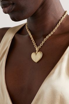 Lauren Rubinski's pieces are equally playful and elegant. Made from 14-karat gold, this necklace is strung with a heart-shaped pendant that slides open to reveal a red enamel heart. 14k Gold Jewelry With Cable Chain For Valentine's Day, 14k Gold Cable Chain Jewelry For Valentine's Day, Elegant Large Pendant Necklace For Valentine's Day, Elegant Valentine's Day Necklace With Large Pendant, 14k Gold Heart Chain Necklace, 14k Gold Heart Pendant With Cable Chain, Luxury Heart-shaped Gold-tone Jewelry, Heart-shaped Gold-tone Jewelry, 14k Gold Cable Chain Necklace For Valentine's Day