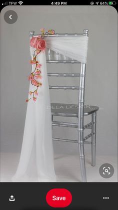 the chair is decorated with pink flowers and white chiffon draped over it's back