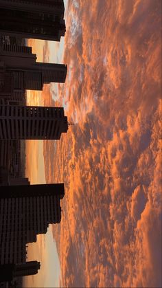 the sky is filled with clouds and buildings