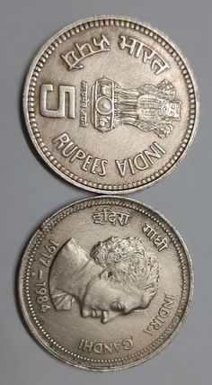 two silver coins with the words india and an image of a lion on one coin