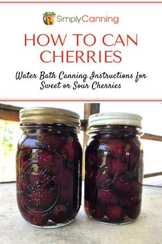 two jars filled with cherries sitting on top of a table