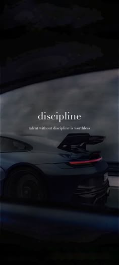 a black sports car driving down a road with the words diseplinne on it