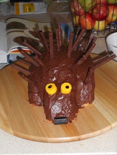 a cake shaped like a hedgehog with chocolate icing on it's face