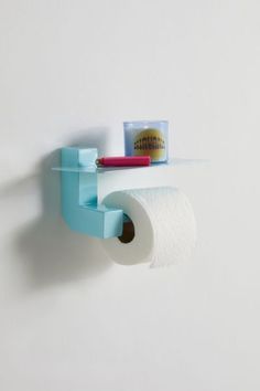 a toilet paper holder with a roll of toilet paper on the wall next to it