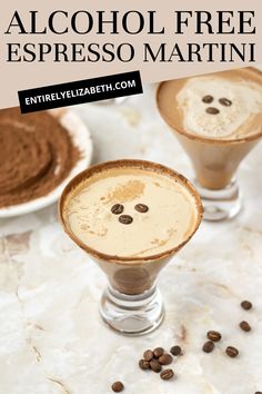 two glasses filled with coffee and topped with whipped cream, chocolate sprinkled on top