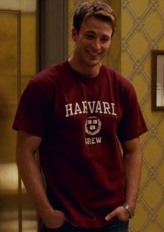 a man standing in front of a door wearing a havari t - shirt