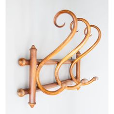 a wall mounted coat rack with wooden handles