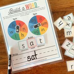 the build a word game with matching letters and numbers is on a table next to some crayons