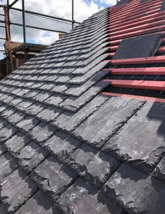 slate roofing being installed on a house