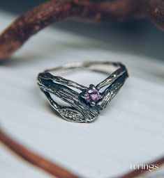 Curved silver branch ring with amethyst is a gift from the forest fairy. These nature symbols wrap your finger and dazzle with stones on this whimsical engagement ring. This graceful design is the perfect way to express your love for nature and your love for your partner. Nature-inspired Promise Jewelry With Gemstones, Nature-inspired Hand Forged Promise Ring, Nature-inspired Promise Rings With Birthstone, Nature-inspired Jewelry Ring With Accent Stones, Nature-inspired Ring With Accent Stones, Nature-inspired Gemstone Rings For Promise, Unique Adjustable Amethyst Promise Ring, Nature-inspired Silver Amethyst Jewelry, Nature-inspired Hand Forged Jewelry For Promise Ring