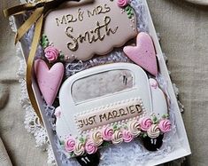 a box with some cookies in it on top of a tableclothed cloth and lace