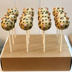 cake pops with leopard print on them sitting on a cardboard box