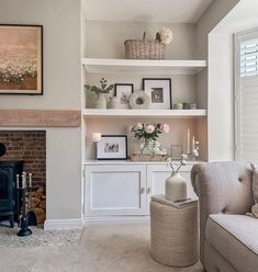 a living room filled with furniture and a fire place in front of a painting on the wall