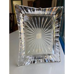 a square glass plate sitting on top of a table