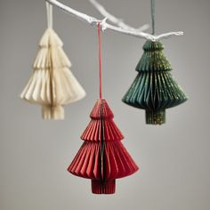 three origami christmas trees hanging from a string