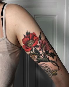 a woman with a flower tattoo on her arm