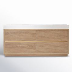 a white counter top sitting on top of a wooden cabinet