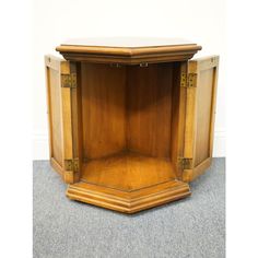 a wooden corner table with two doors on each side