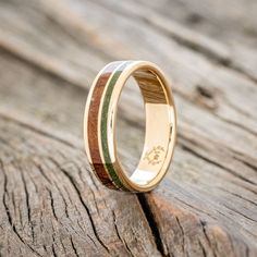 a wooden ring with two different colored wood inlays on the inside of it