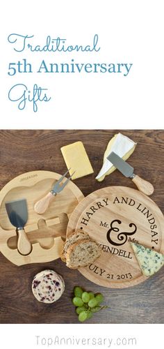 a wooden cutting board with cheese and bread on it next to some other food items