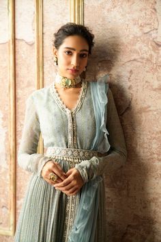 Editor's Note This set features a powder blue anarkali with intricate folk prints and embroidery, creating a stunning and unique look. It is paired with a net ruffled dupatta for added volume and drama, as well as an embroidered pearl drop belt that adds a touch of elegance to the ensemble. The combination of traditional and modern elements in this set makes it a perfect choice for special occasions. Color: Blue Fabric: Net; chiffon Components: Anarkali, dupatta and belt Occasion: Festive Discla Ruffle Dupatta, Ridhi Mehra, Blue Anarkali, Folk Print, Wedding Dress Jewelry, Embroidered Anarkali, Desi Wear, Bridal Choker, Embroidered Crop Tops