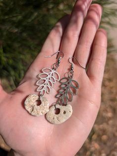 Earrings featuring sterling silver ferns and dangling natural fairy stones. Jump rings and earring hooks are silver colored. Fairy Stones, Fern Earrings, Fairy Stone, Silver Fern, Wedding Jewelry Earrings, Earring Hooks, Jump Rings, Wedding Earrings, Fern