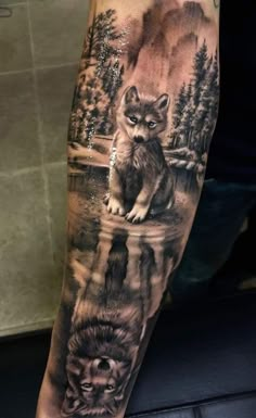 a man's arm with a wolf and cub tattoo on the left inner forearm