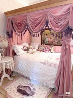 a bedroom with pink curtains and teddy bears on the bed, rugs and chairs