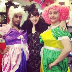 three people dressed in costumes posing for a photo