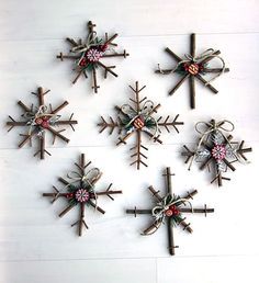 six snowflakes are hanging on the wall with ribbons and decorations around them