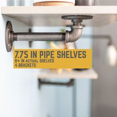 a metal shelf with some pipes attached to it and a yellow sign that says 755 in pipe shelves